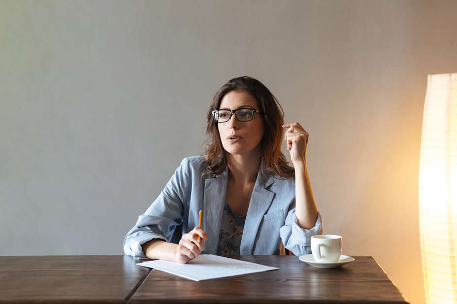 Woman thinking about what to write