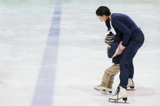 Mother helping child skate