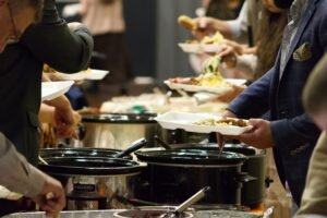 People serving themselves at a potluck dinner